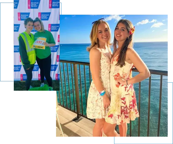 Two girls posing for a picture in front of the ocean.